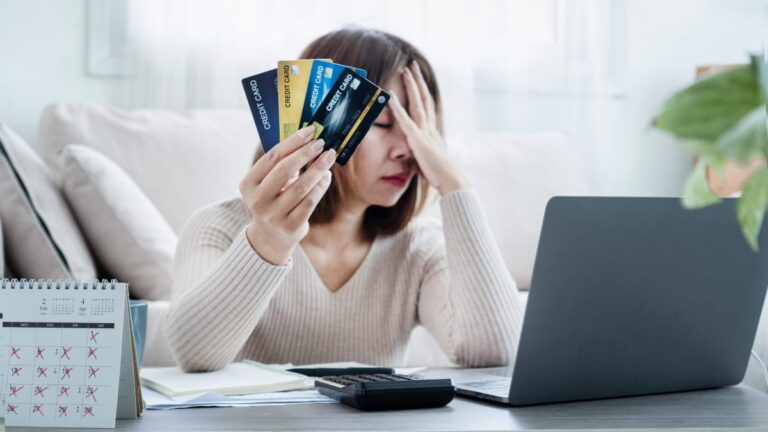woman with multiple credit card showing debt spiral